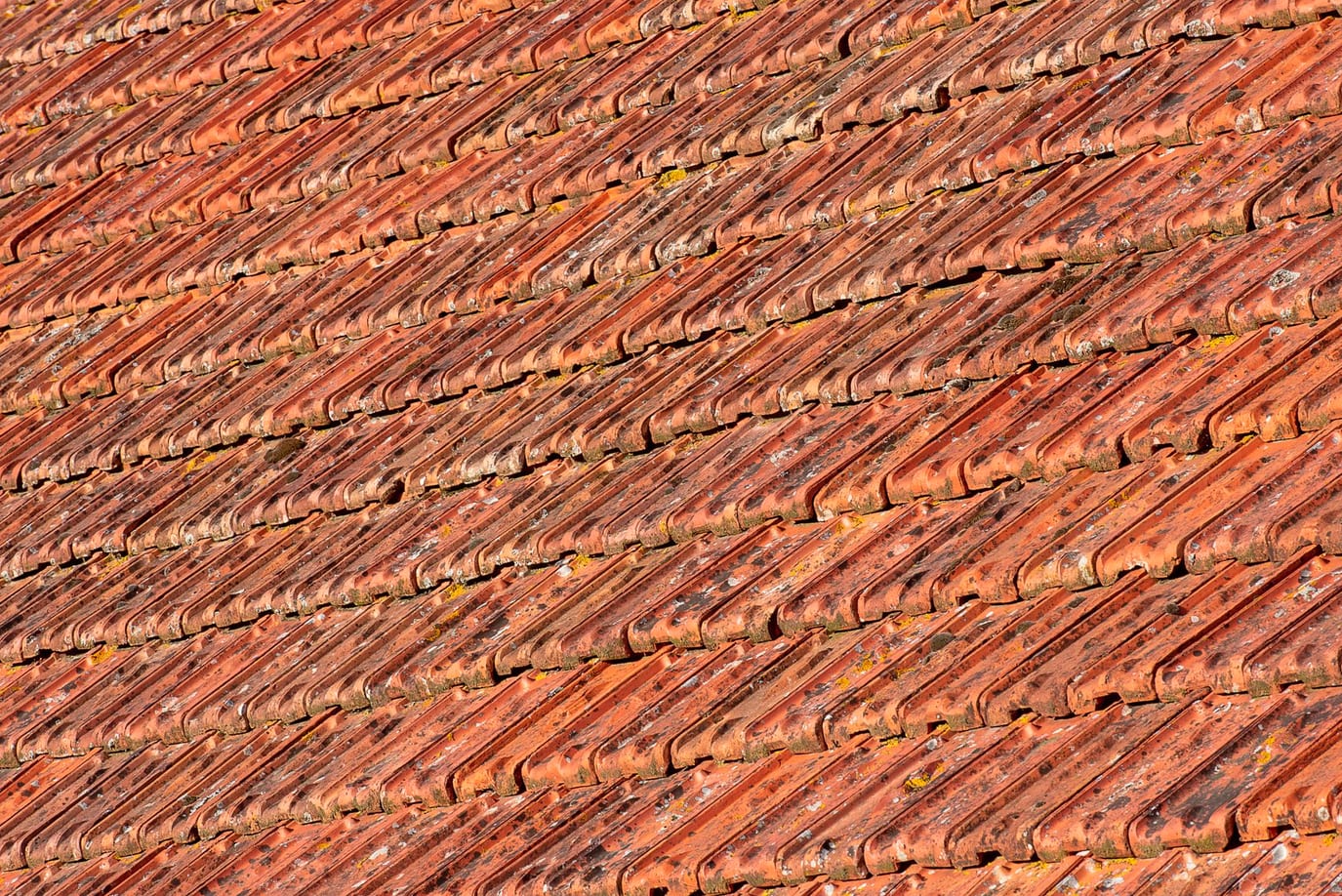 Pile of terracotta clay roof tiles ready for dispatch